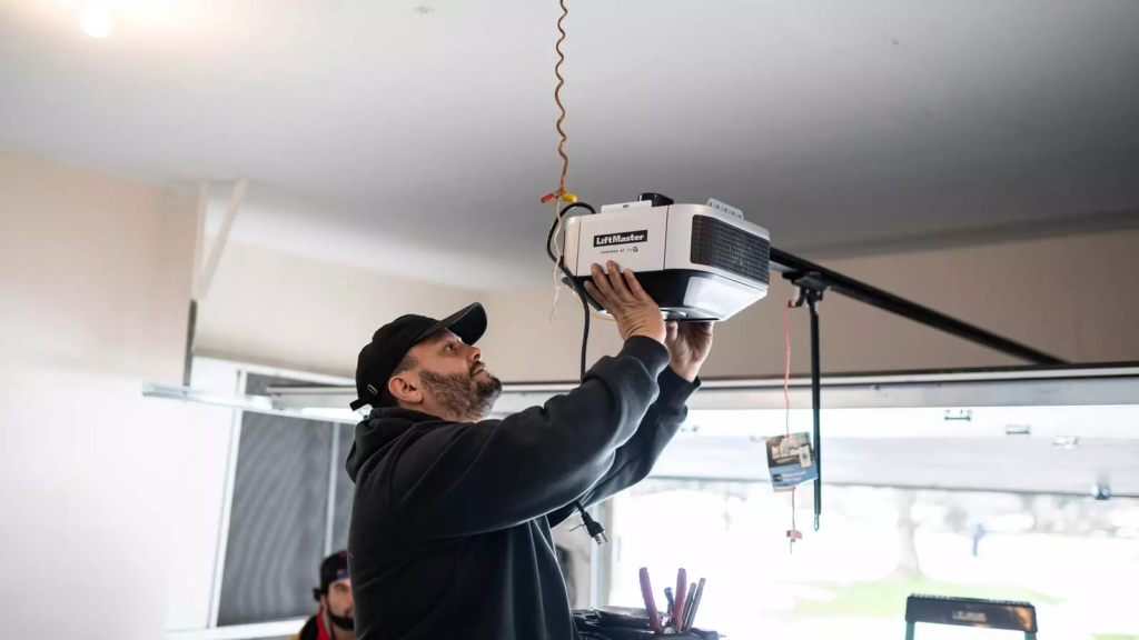 Technician installing a garage door opener.